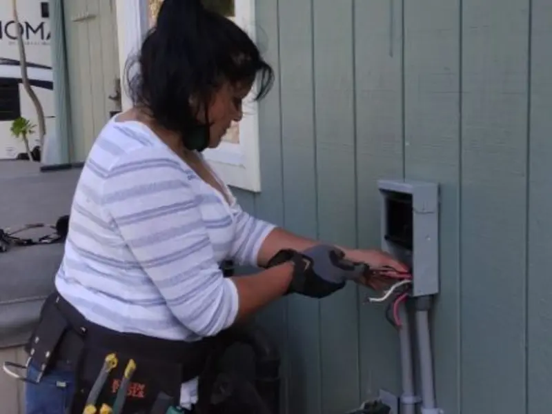 Licensed electrician wiring an exterior subpanel in Carney
